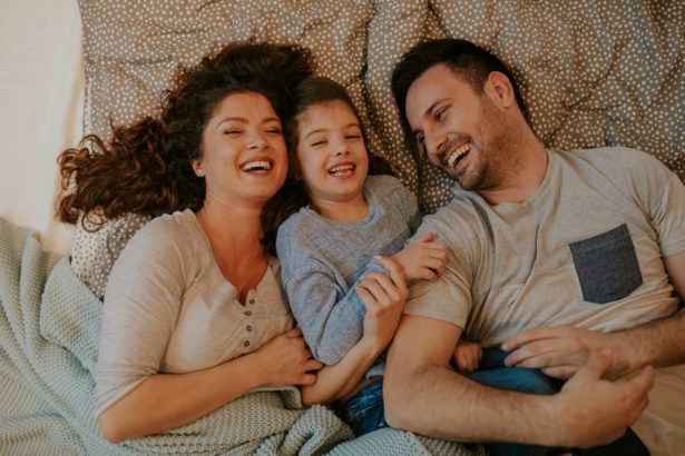 Overhead photo of young parents spending quality time with their cute little daughter.