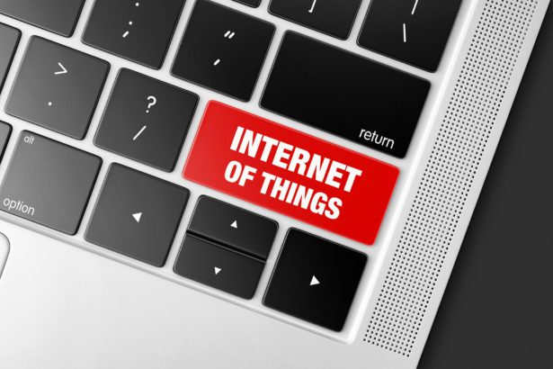 Red Internet of things key on a black computer keyboard, concept picture of modern technology trends